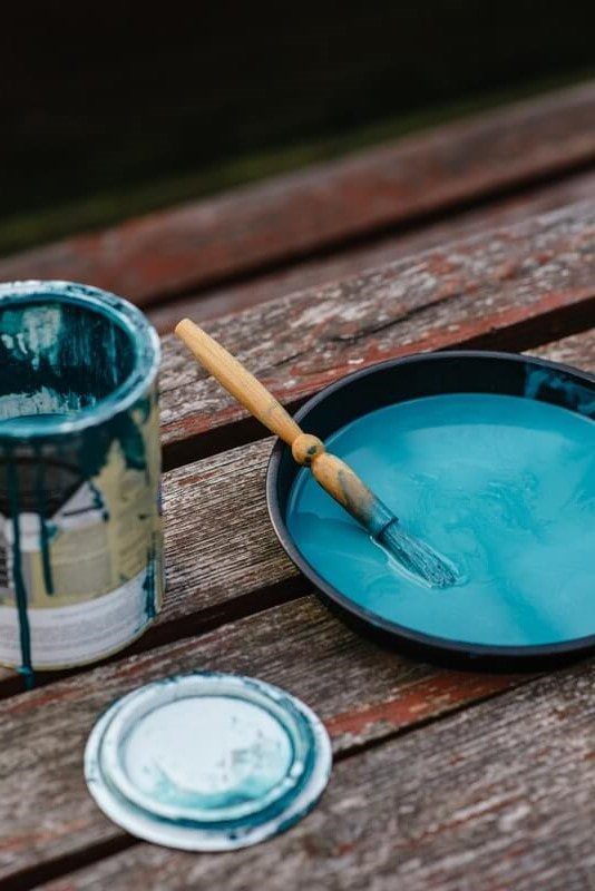 Paintbrush resting on paint tray